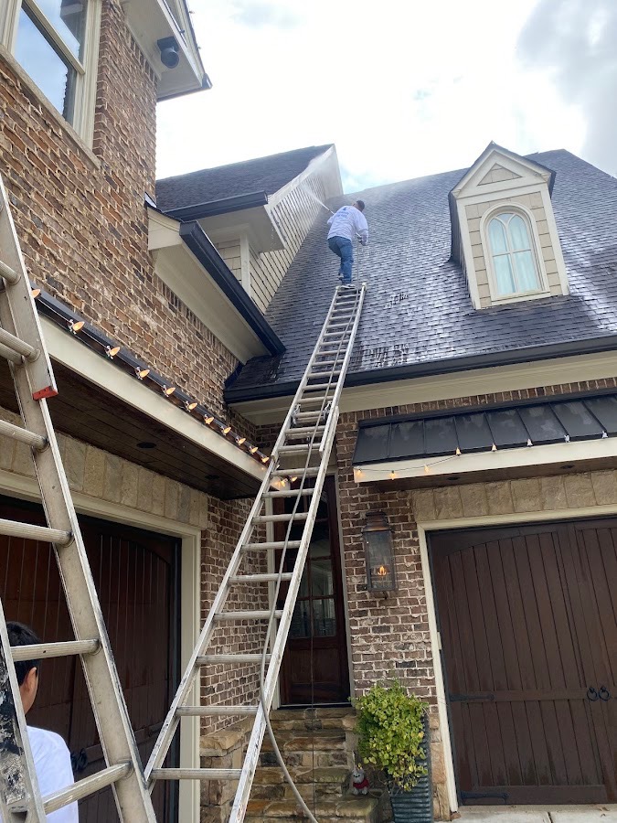 Residential exterior painting with ladder work