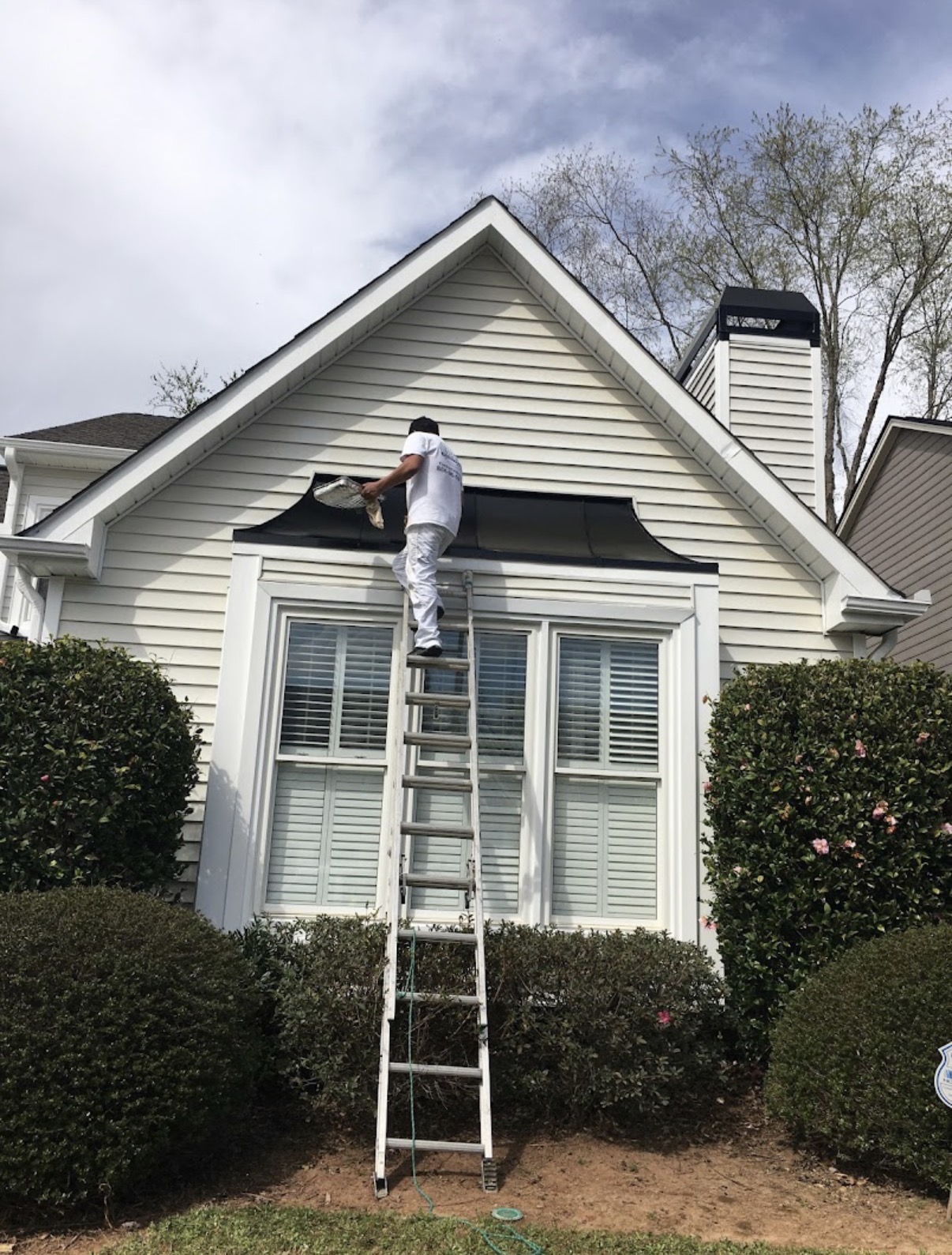 Exterior gable trim painting on cottage-style Atlanta home