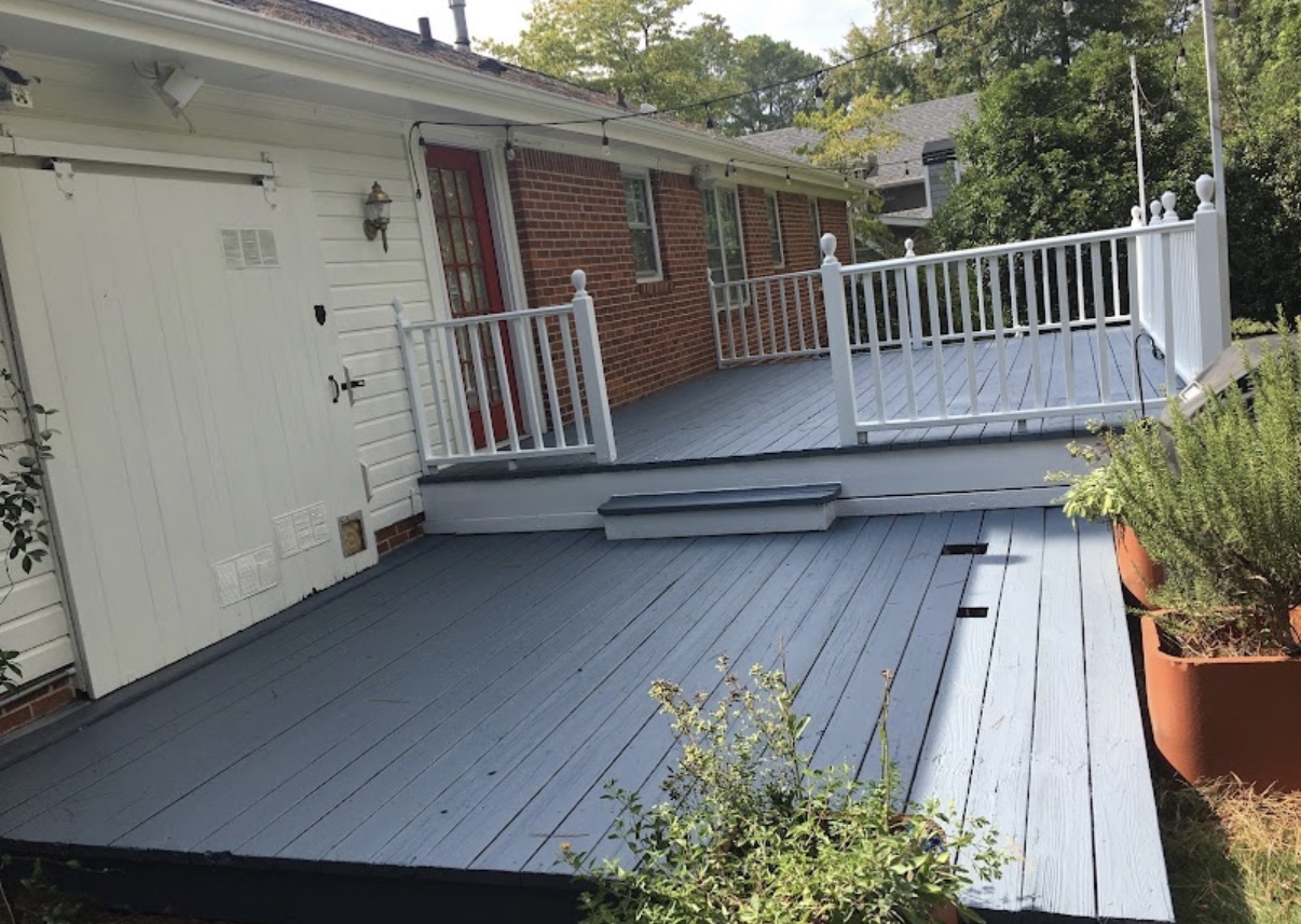 Finished slate-painted deck with white railings by Pine Peach Painting